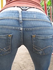 Sexy chick in tight blue jeans up skirt pic