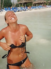 Bikini girls love getting sun tanned on the beach upskirt pic