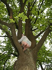 Doll in skirt climbs up the tree and has her cunt bared candid upskirt