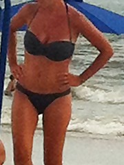 Sexy bikini babes sit on the beach upskirt shot