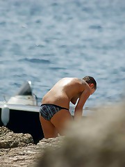 Bikini voyeur man working on beach upskirt photo