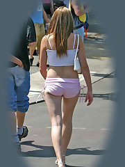 Cute blonde gets spied wearing fishnets and shorts