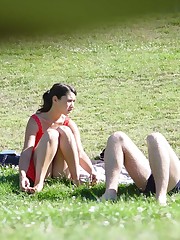 Squat upskirt. Squatting brunette on a glade voyeured