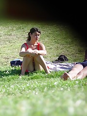 Squat upskirt. Squatting brunette on a glade voyeured