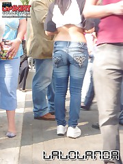 Smiling babe in jeans wears no top